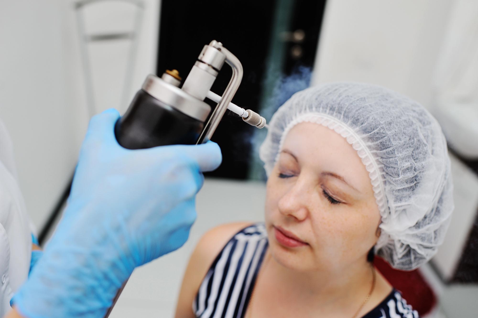 Doctor makes the patient Cryomassage